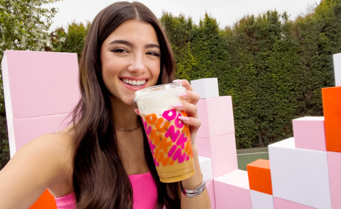 Charlie D'Amelio holding a Dunkin Iced Coffee